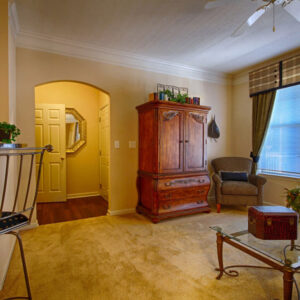 Large living room with window and breakfast bar at The Legends Apartments
