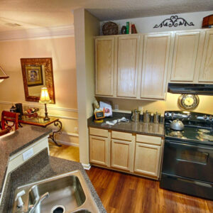 Apartment with updated kitchen with wood floors and opening concept - The Legends Apartments