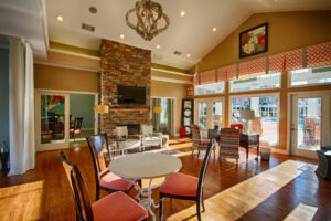 Apartment club house with fire place and patio with pool - The Legends Apartments