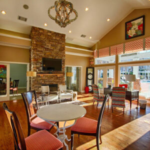 Apartment club house with fire place and patio with pool - The Legends Apartments