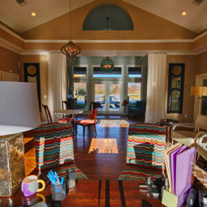 Apartment club house with seating area and fireplace - The Legends Apartments