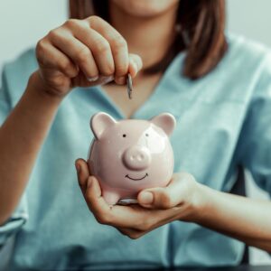 woman placing money in bank