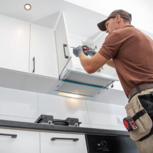 man fixing cabinet