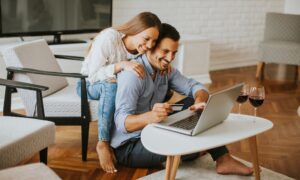 couple looking at lapto[