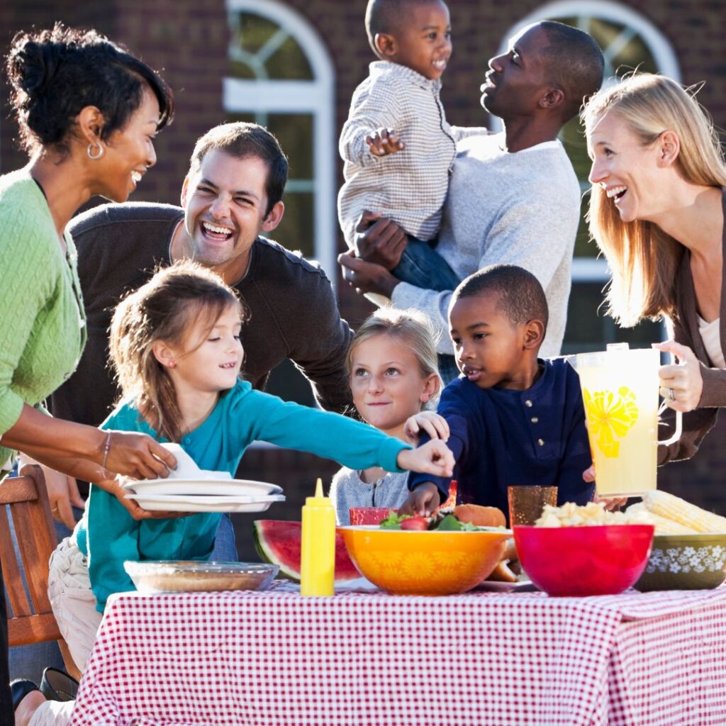 multiple families with kids having barbecue