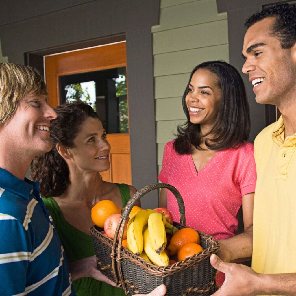 people sharing fruit basket