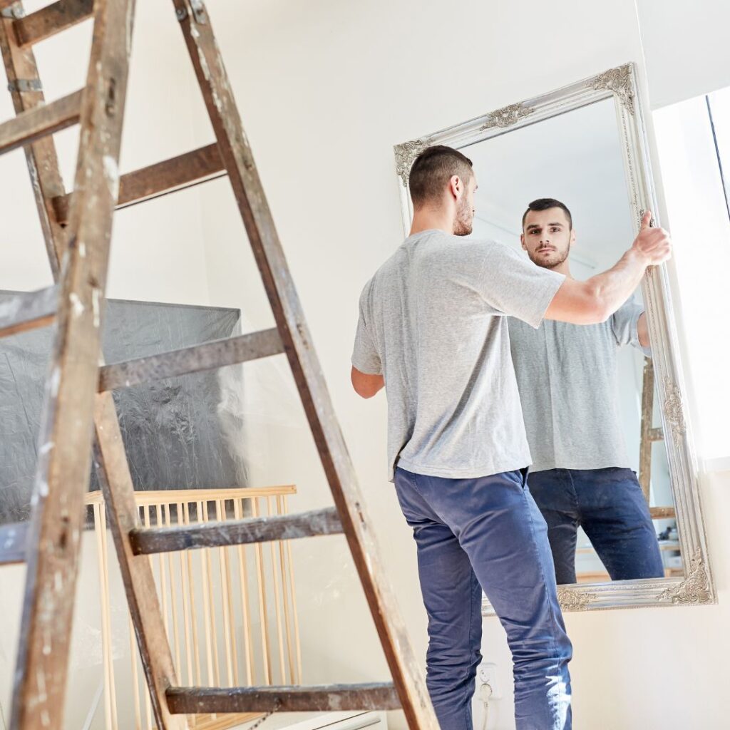 man moving in with mirror