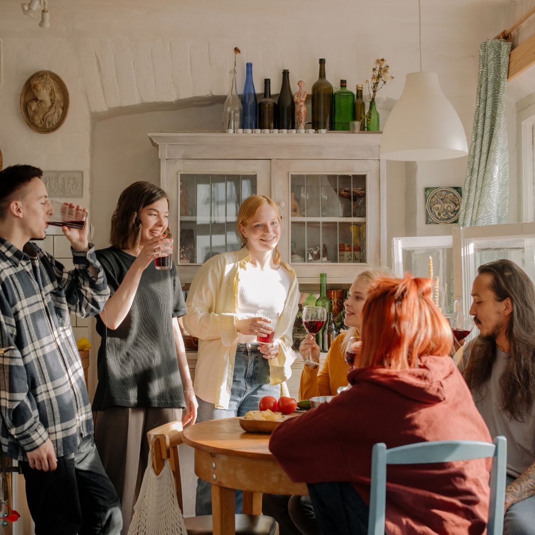 friends gathered in apartment kitchen