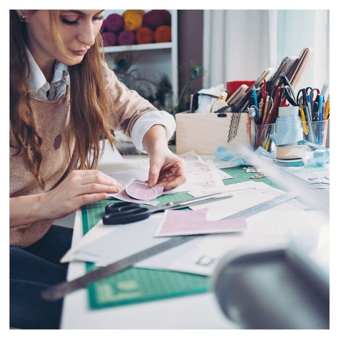 woman doing crafts at table